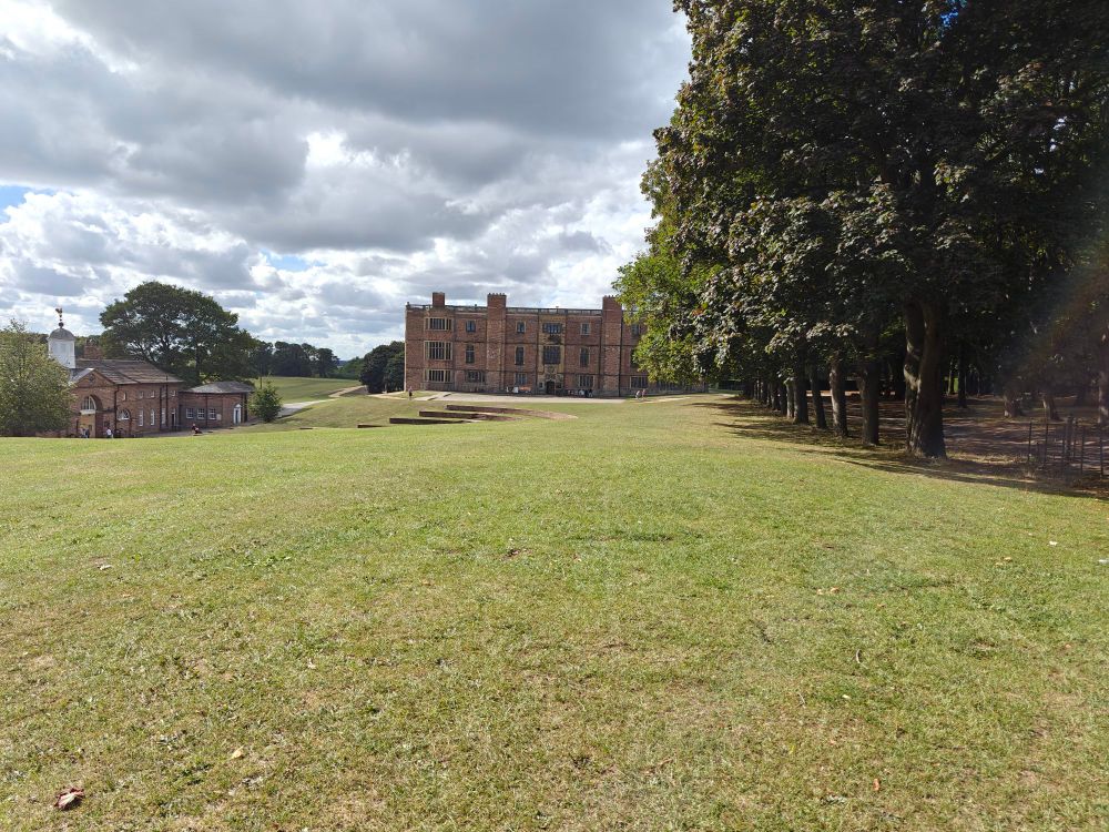 A green lawn and a stately home
