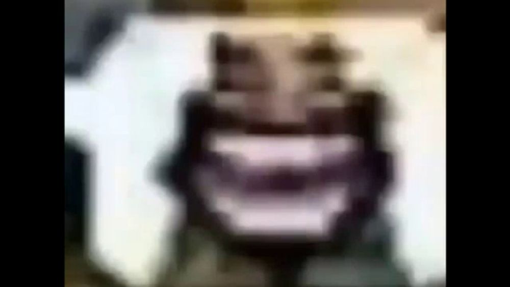 a blurred image of a person 's face with a crown on their head .