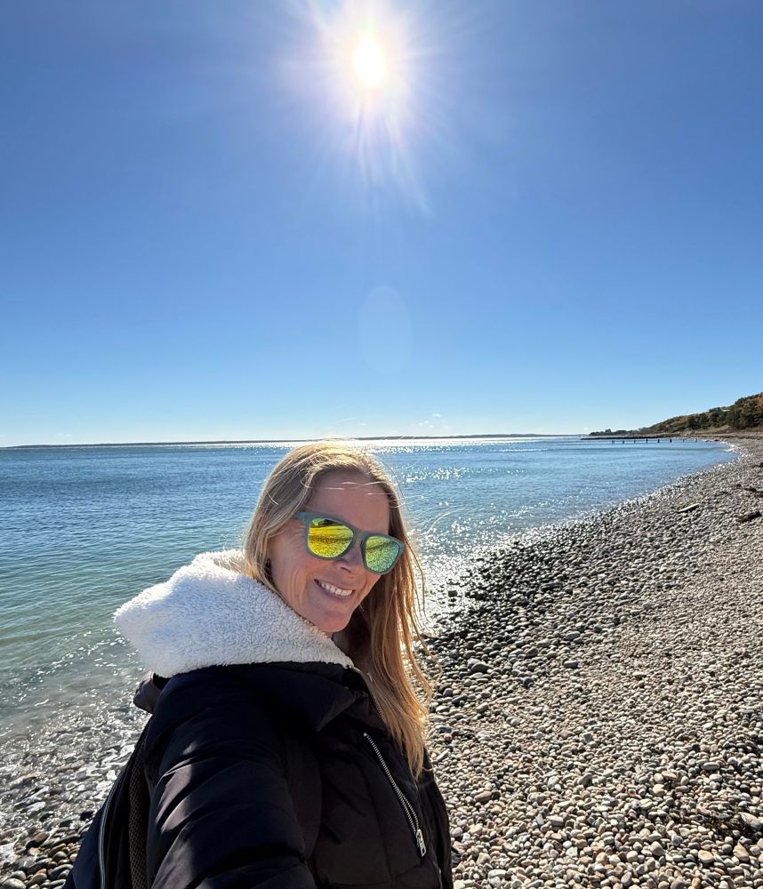 Woman on the beach smiling 