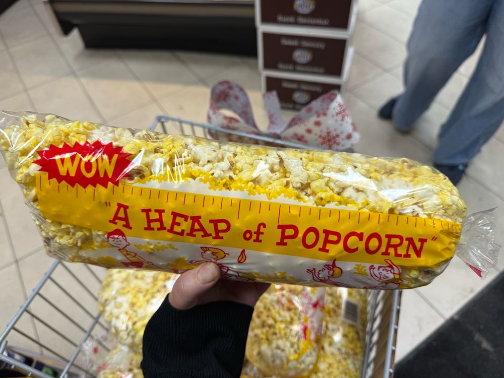 Hand holding a bag of popcorn with ruler markings and the title “A heap of popcorn.”