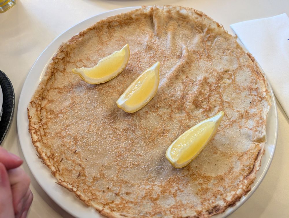 A large crepe with sugar and lemon