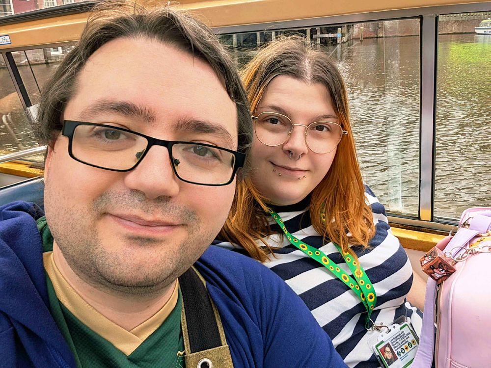 My fiancé and I on a boat, smiling at the camera.