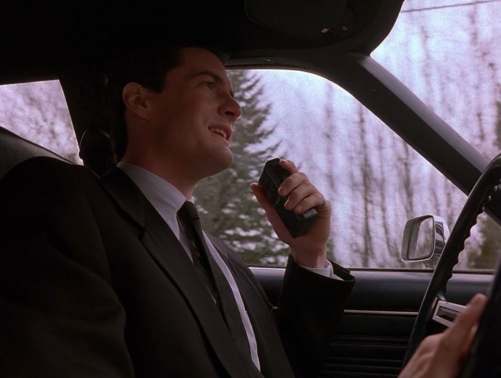 Special Agent Dale Cooper in the car with his tape recorder in Twin Peaks pilot episode