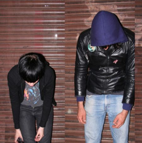 cover of the 2008 self-titled album by Crystal Castles. Features two individuals leaning over, looking at the ground. 