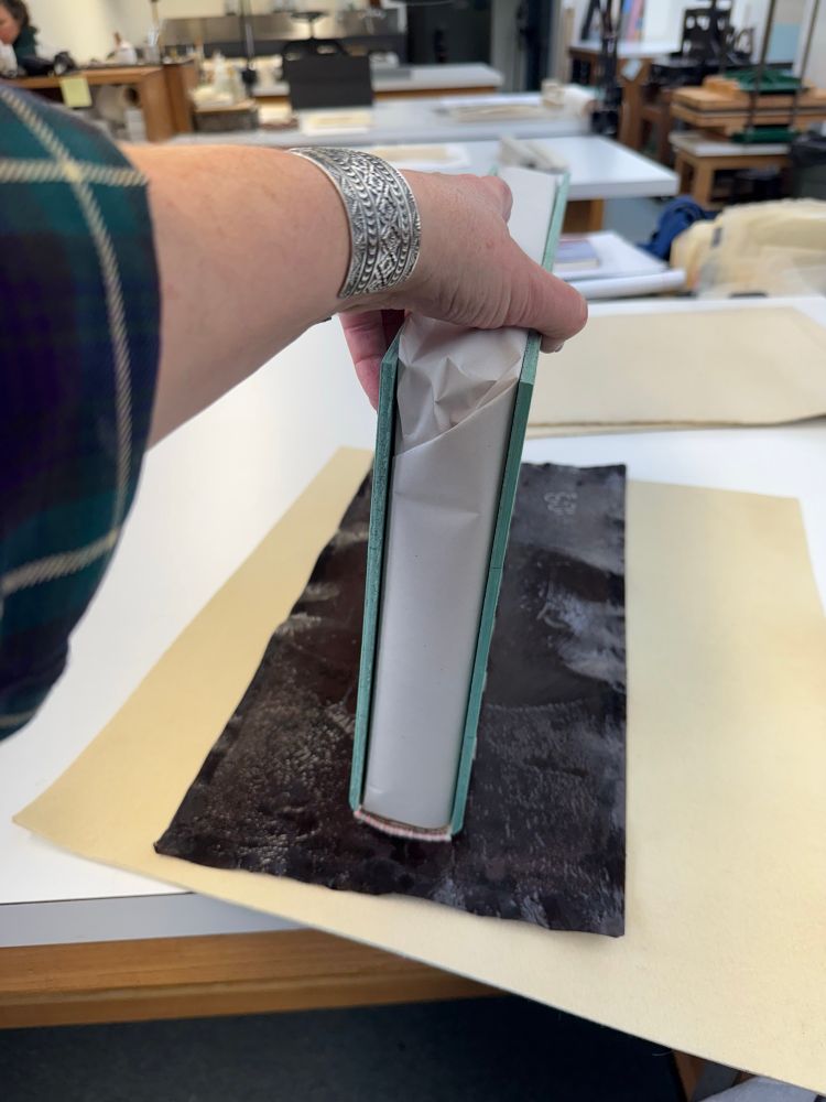 A bound volume in the process of getting a new leather spine