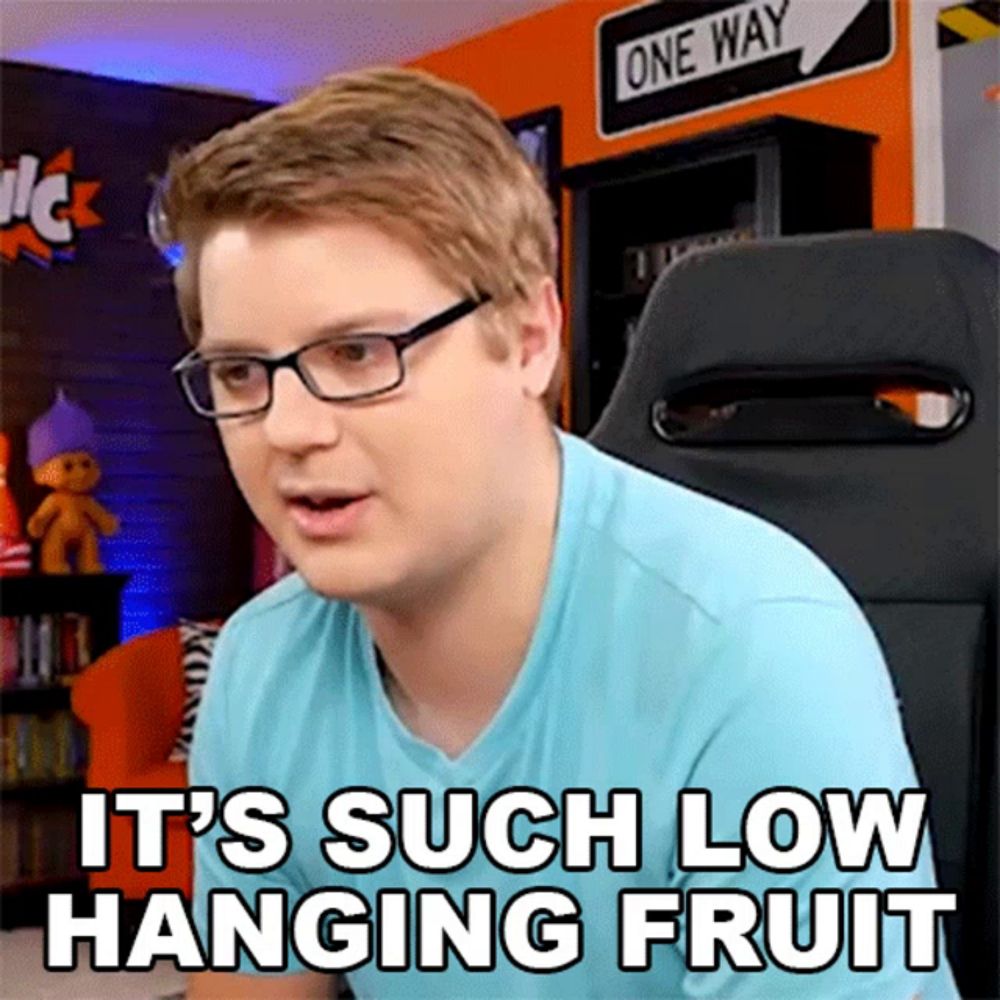 a man wearing glasses says it 's such low hanging fruit while sitting in a chair