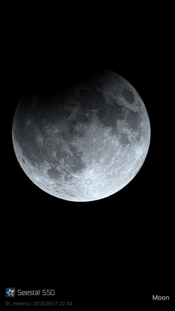 An image of the (very) partially eclipsed moon.  The background is starless, and about 1/5 of the moon.  The left upper portion of the moon is dark, obscuring about half of the Mare Imbrium and just touching Mare Serenitatus.  The rayed crater Tyco is very prominent at the bottom of the moon, with rays  stretching up and left into Oceanus Procelarium and up and right to touch Mare Nectaris.
