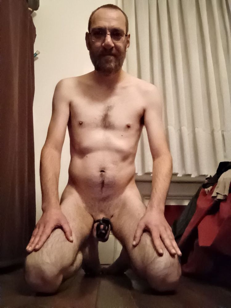 Me on my knees, naked and my dick locked.
