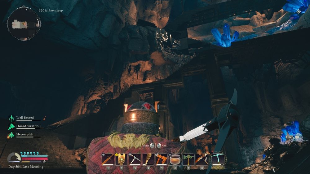 A helmeted Dwarf kneels in a large dimly-lit cavern. Glowing blue crystals have erupted from the rock in various places. He clutches a pickaxe. He is looking up into the distance at tall winding ascending stairs and the bridge.