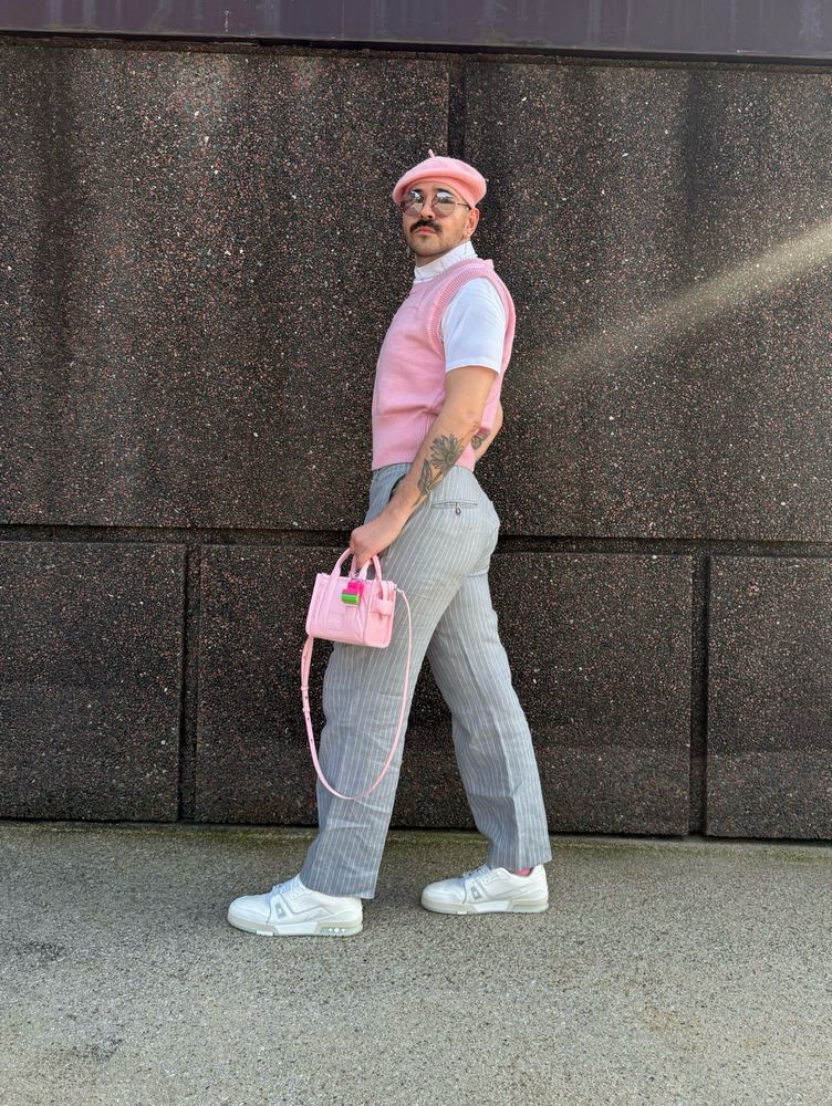 Outfit picture, wearing a pink sweater vest, white button up, pink beret, pink tote bag, grey pin stripe slacks and white sneakers