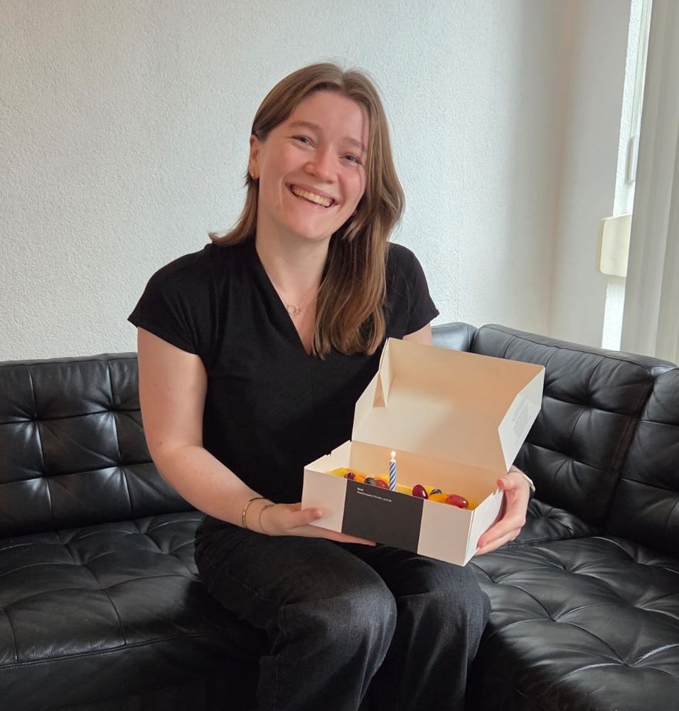 Sophie van Oers, founder and owner of Van Oers Voiceovers, holding a cake. She's celebrating the one year anniversary of her own company!