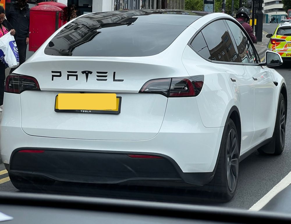Tesla with PATEL in large letters on the back incorporating the T logo