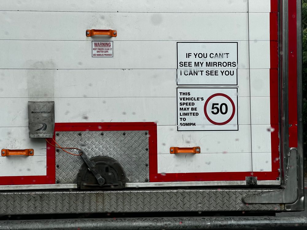 Back of a truck with a speed limited being indicated as 50 mph, with text saying the vehicle might be limited to 50 mph