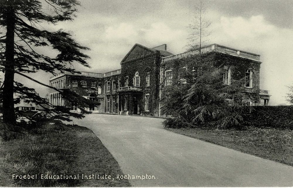 An old monochrome picture postcard showing an ivy-clad large house. Printed at the foot of the card in what looks like a 1920s version of comic sans is "Froebel Educational Institute, Roehampton"