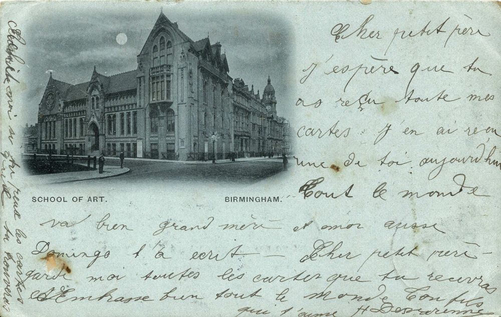 An old monochrome picture postcard showing the School of Art in Birmingham, with a message written around the image in hard-to-read French handwriting