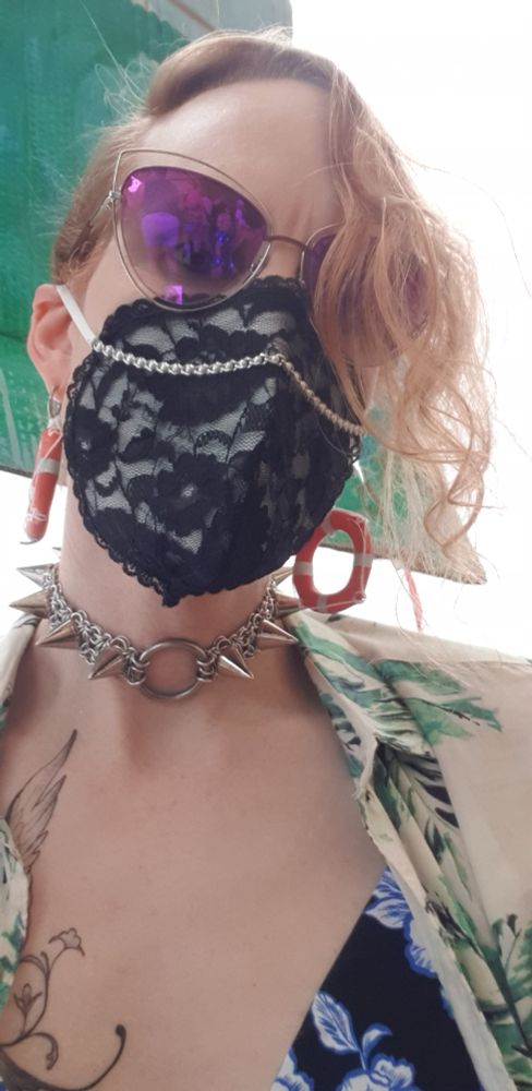 Close-up selfie at the event. I'm now also wearing a white mask with black lace and a chain, my spike choker, and lifebouy earrings. It's about 5pm so it's still fairly light in the outside area, despite being overcast.