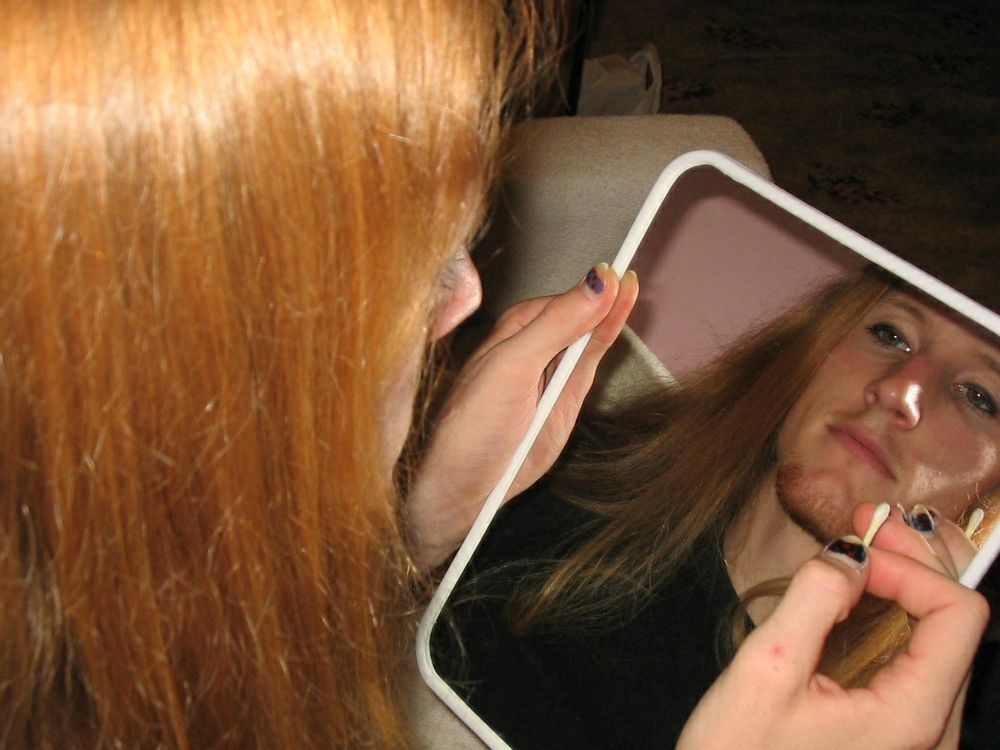 Shot of me looking into a mirror. I'm probably in the middle of fixing my eye makeup. I didn't know how to do it well back then so they're a little too dark.