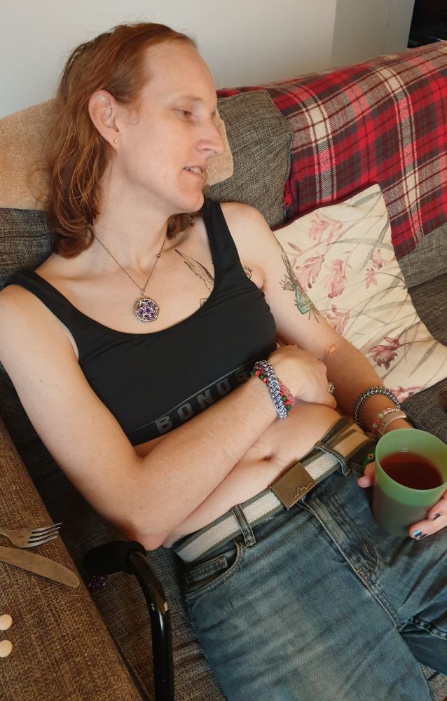 I'm on the couch, slumped a little to the side, looking helpless.

I asked Cassie to take this photo; she's not a monster.