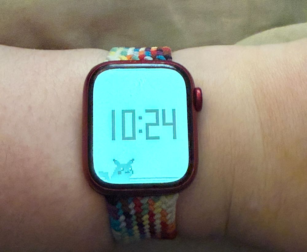 an old beat up red apple watch series 7 displaying the pokétch app described in the post. it is currently displaying the time