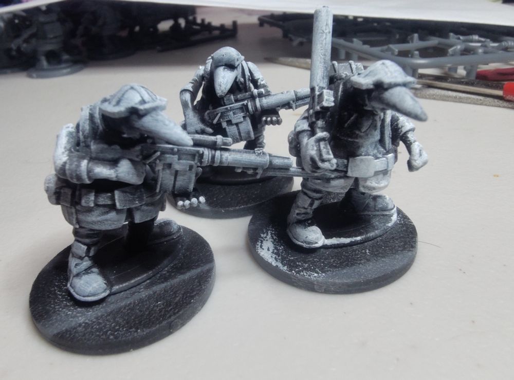 Three miniature soldiers from the game Quar, where anteaters have entered forever war.
