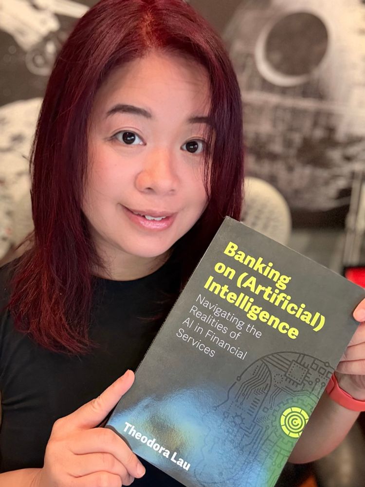 Author holding up a book, titled banking on artificial intelligence. 