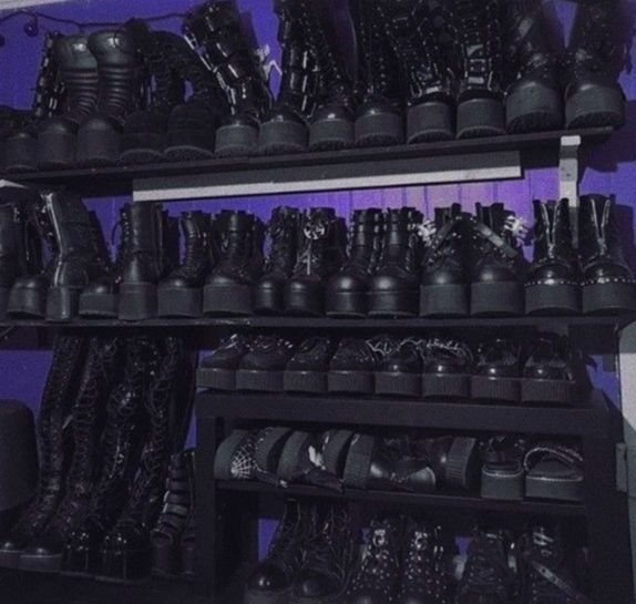 A photo of a closet full of black leather shoes on every self