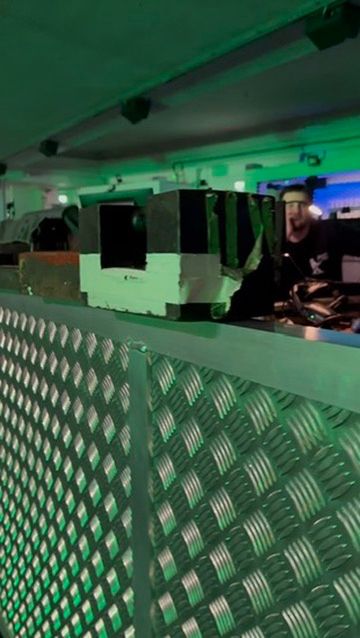 A panning shot along a metal barrier to the front of house area of a venue with FIFTEEN different cast iron weights lined up along it. A sardonic thumbs up is given to the collection at the end of the video.