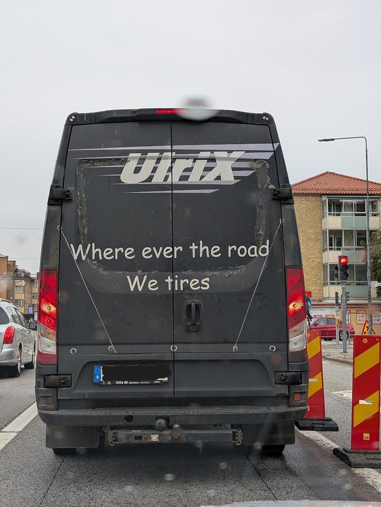 A work van with the slogan "Where ever the road. We tires"