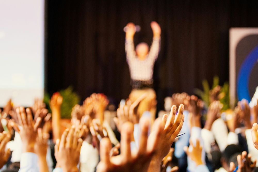A speaker takes applause. Photo by Jaime Lopes on Unsplash