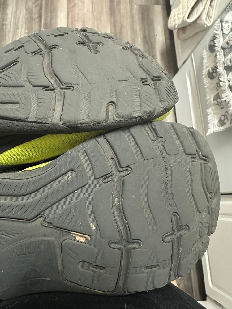 A worn down pair of Brooks shoes