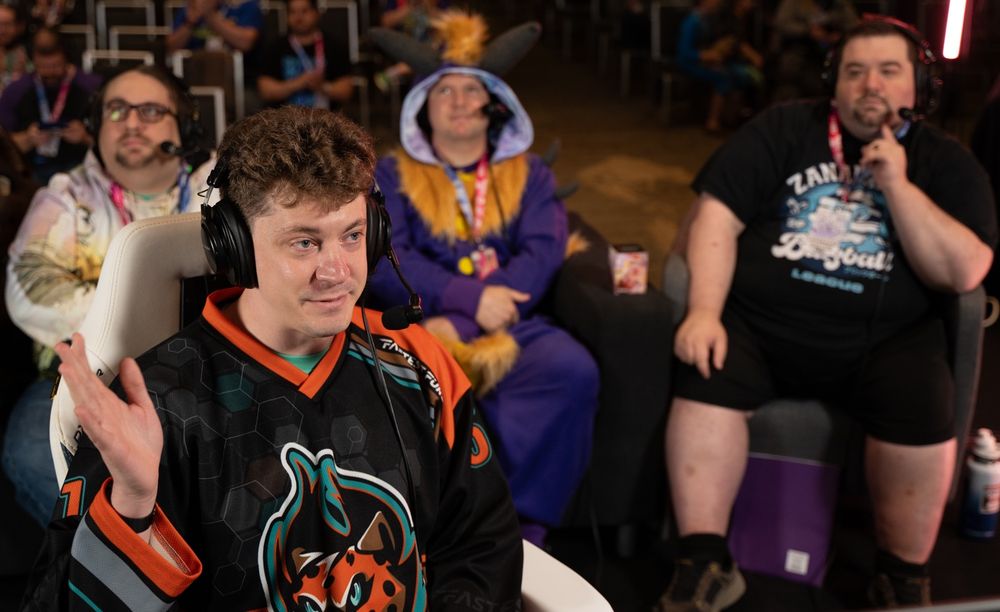 Runner for FF9 on stage about to start a run with three commentators in the background.