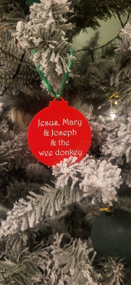 Red decoration with "Jesus, Mary and Joseph and the wee donkey" in white