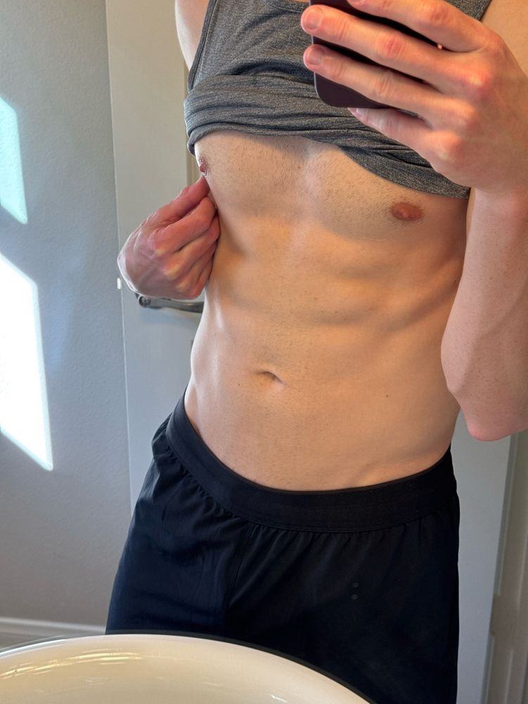 Mirror selfie showing abs and nipples