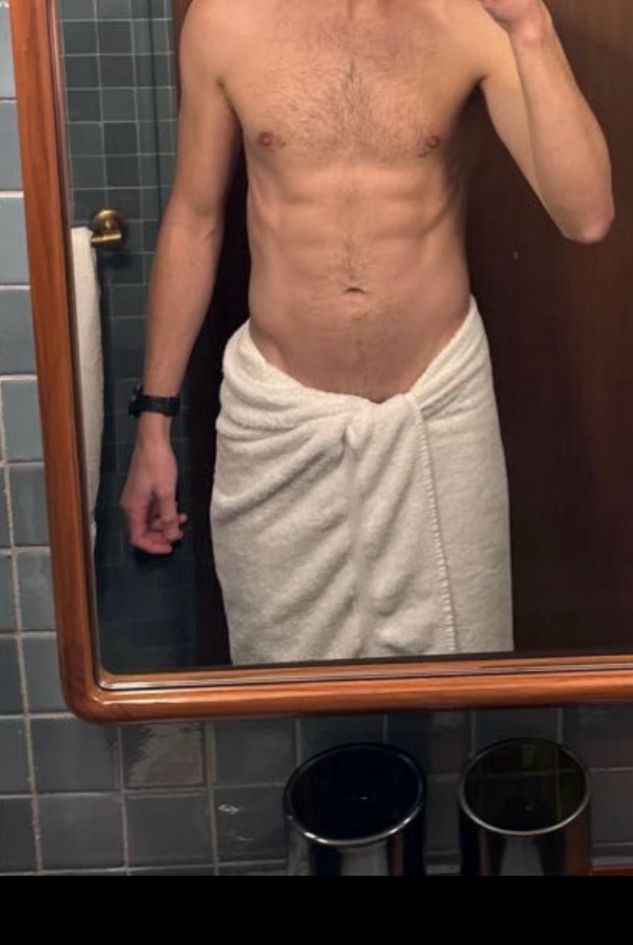 Mirror selfie of guy with towel around waist