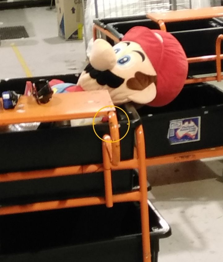 a stuffed mario that is slumped and deflated in a way that makes it look very much like a luigi