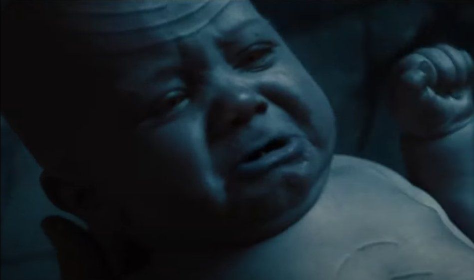 a blue baby with red eyes (according to the other image search result, not apparent here) & a bunch of lines on it that look like star trek prosthetics except maybe made of computers. the baby is named loki marvelmovie & it's blue