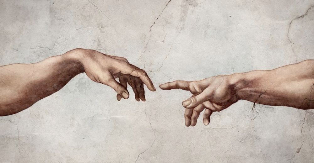 Detail from the The Creation of Adam, fresco by Michelangelo on the ceiling of the Sistine Chapel's ceiling, two hands reaching towards each other, almost touching