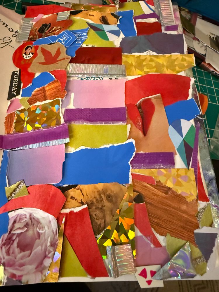 An abstract collage made of little bits of torn and cut paper leftovers. It is colorful and some of the bits are sparkly.