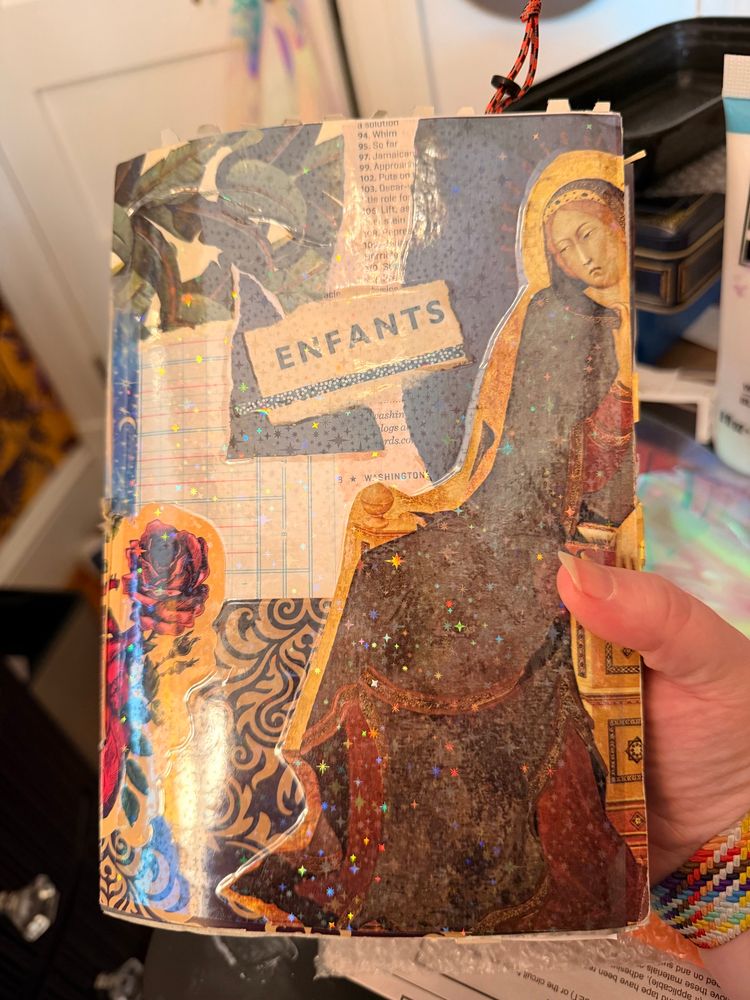 A homemade journal covered in collage.