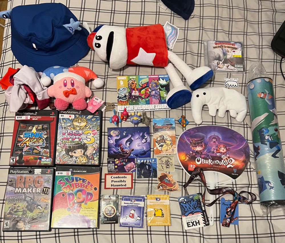 A big, treasure trove of various objects and knick knacks I picked up over the course of PAX West 2025.