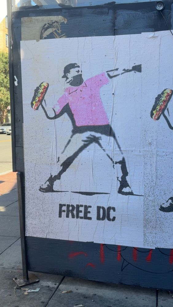 The Banksy esque street art that says “Free DC” and the guy is throwing a sandwich 