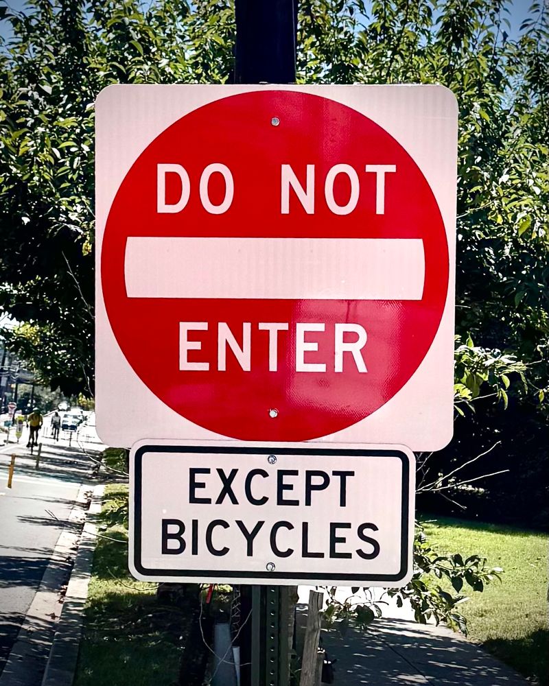 A “Do Not Enter” traffic sign, with a sign below it that states “EXCEPT BICYCLES”. 