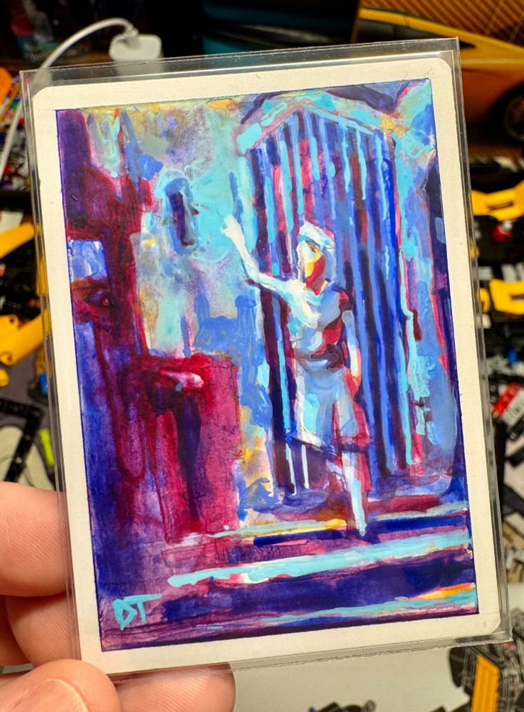 The back of the Arcane Signet features a painting of a figure descending a staircase in front of a gate, one arm reaching toward a glowing blue light above, with shadows rendered in deep reds and purples.
