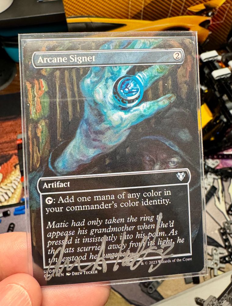 The front of an Arcane Signet artist proof signed by Drew Tucker in silver color cursive.