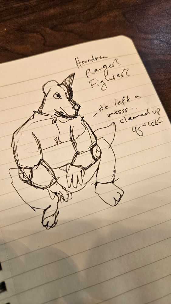 A small lined notebook with a messy pen sketch of a humanoid dog furry figure with one ear up, one ear down, wearing chain mail and loose pants, looking off in the distance. Notes written next to it say "Hound man ranger? Fighter?" And have him saying in a speech bubble, "he left a mess... cleaned up quick"