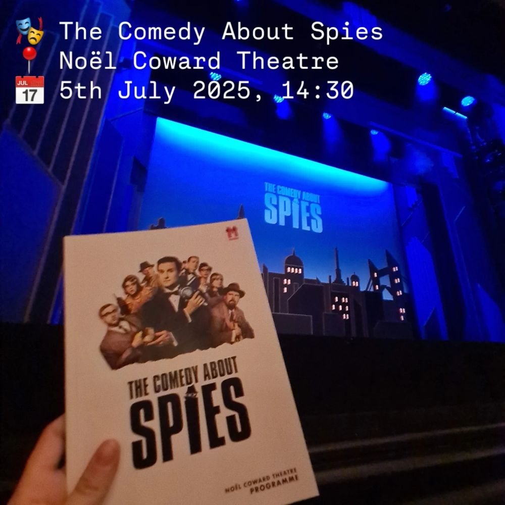 A photograph of my hand holding The Comedy About Spies programme I front of the stage before the show.
Image text reads:
🎭 The Comedy About Spies
📍 Noël Coward Theatre
📅 5th July 2025, 14:30