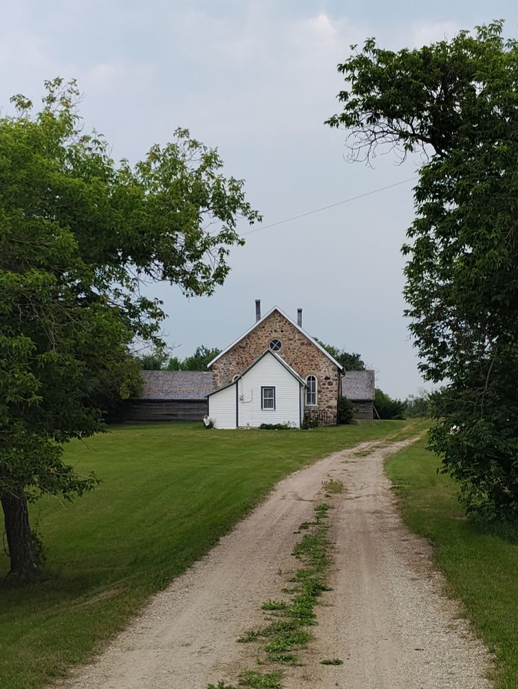 The little Stone church at Moffat, south east Saskatchewan, and the grid road leading to it