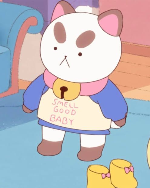 Puppycat in a blue and white sweater with pink lettering declaring him a “Smell Good Baby” 