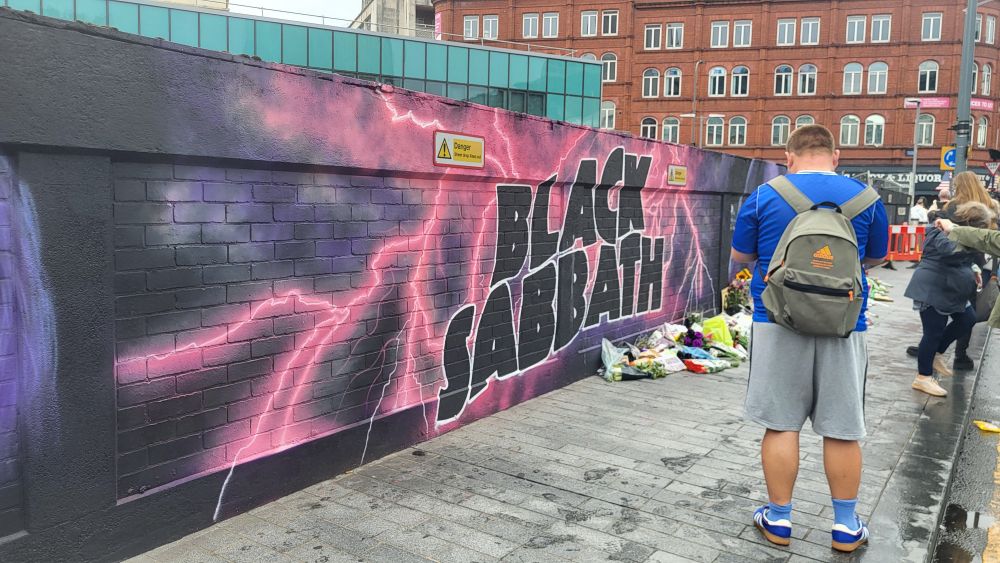A brick wall featuring graffiti of the Black Sabbath logo