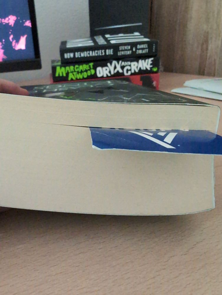Book on its edge with a bookmark showing how much has been read so far.